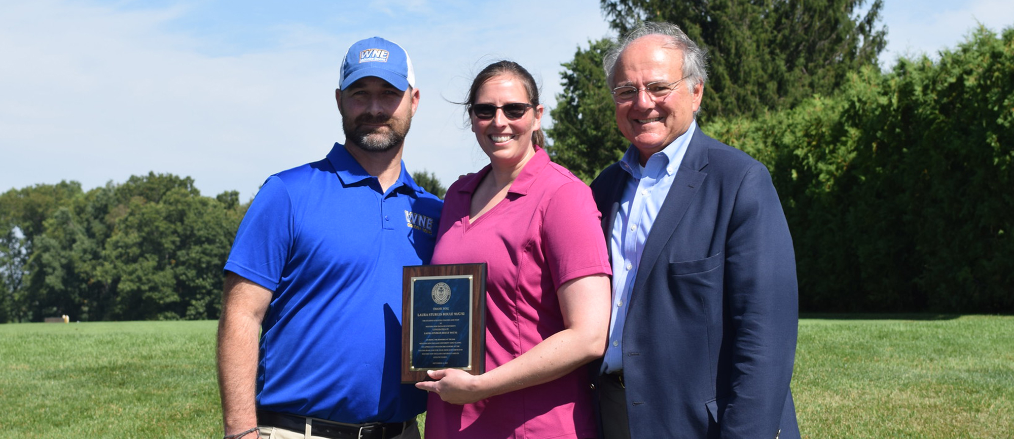 Former Golden Bear women's lacrosse student-athlete and current Vice President of Residential Asset & Property Management at Nordblom Company, Laura Sturgis Boule '01/G'02, was recognized as the Guest of Honor at the 21st Annual Golf Classic on Monday. Sturgis Boule (middle) is pictured here along with Director of Athletics Matthew LaBranche (left) and University President Dr. Anthony S. Caprio (right).